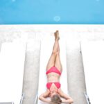 Pool Decks - Woman Lying on White Sun Lounger