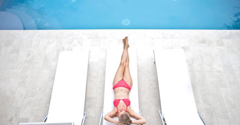 Pool Decks - Woman Lying on White Sun Lounger